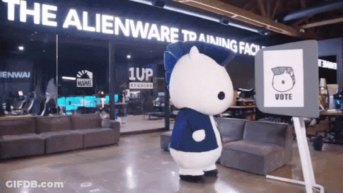 A Mascot In Front Of A Sign That Says " Vote " GIF