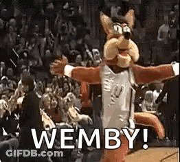 A Mascot Is Dancing In Front Of A Crowd At A Basketball Game And Says Wemby . GIF
