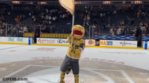 A Mascot Is Holding A Flag In Front Of A Sign That Says Las Vegas On It GIF
