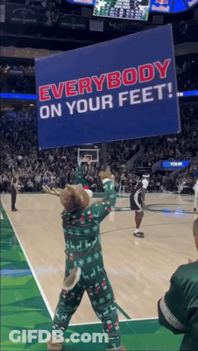 A Mascot Is Holding A Sign That Says Everybody On Your Feet GIF