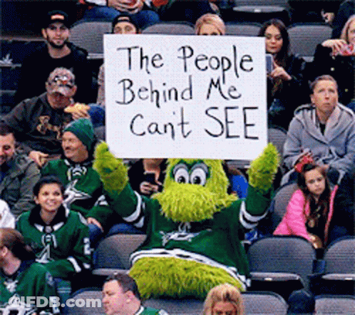 A Mascot Is Holding A Sign That Says The People Behind Me Can 'T See GIF