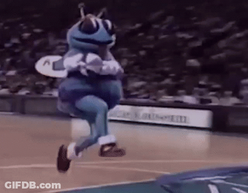 A Mascot Is Jumping In The Air On A Basketball Court . GIF