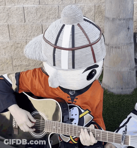 A Mascot Is Playing A Guitar And Wearing A Hockey Jersey GIF