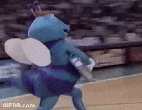 A Mascot Is Playing Basketball On A Court . GIF