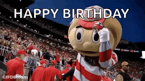 A Mascot Is Standing In Front Of A Crowd In A Stadium And Says Happy Birthday . GIF