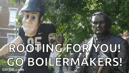 A Mascot Is Standing Next To A Statue Of Abraham Lincoln . GIF