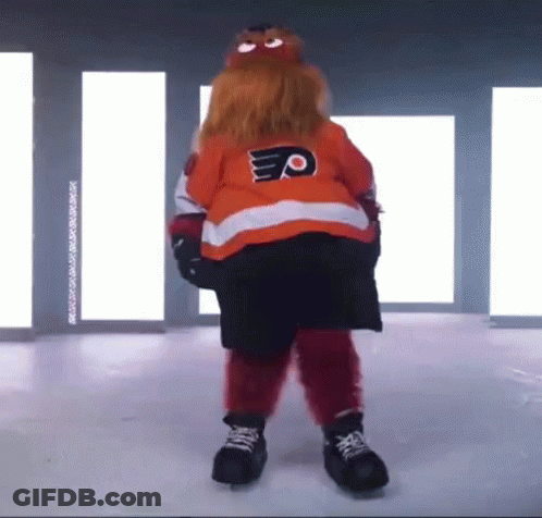 A Mascot Is Standing On A Ice Rink Wearing A Jersey With The Letter P On It . GIF