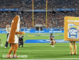A Mascot Is Walking On A Football Field While Holding A Box That Says Popeye 'S GIF