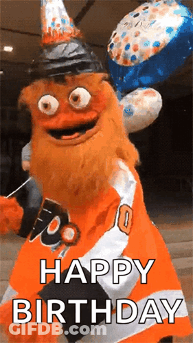 A Mascot Is Wearing A Birthday Hat And Holding Balloons And Says Happy Birthday . GIF