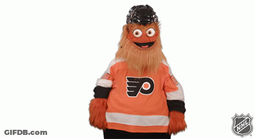 A Mascot Is Wearing A Flyers Jersey And The Nhl Logo Is Behind Him GIF
