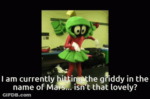 A Mascot Named Marvin The Martian Is Dancing In A Room GIF