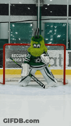 A Mascot Wearing A Bauer Goalie 'S Glove Is Standing In Front Of A Net GIF