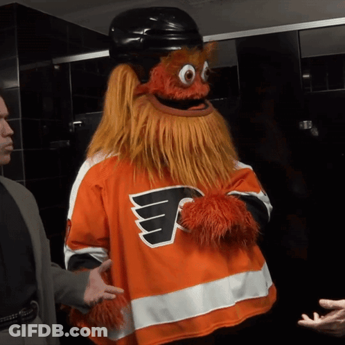 A Mascot Wearing A Flyers Jersey Talks To A Man GIF