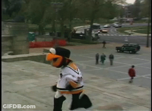 A Mascot Wearing A Jersey With The Number 23 On It Is Running Down A Set Of Stairs GIF