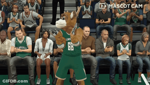 A Mascot Wearing A Number 68 Jersey Stands In Front Of A Crowd GIF