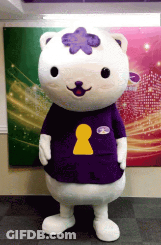 A Mascot Wearing A Purple Shirt With A Yellow Keyhole On The Chest GIF