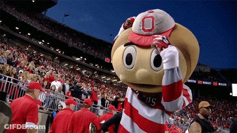 A Mascot Wearing A Red And White Striped Shirt With The Letter O On It GIF