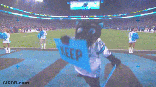 A Mascot With A Sign That Says Keep On It GIF