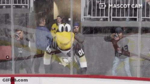 A Mascot With The Number 01 On It Is Behind A Glass Wall GIF