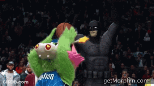 A Mascot With The Number 2000 On His Jersey Is Standing Next To A Batman GIF