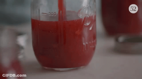 A Mason Jar Filled With Red Liquid Has The Number 300 On The Side GIF