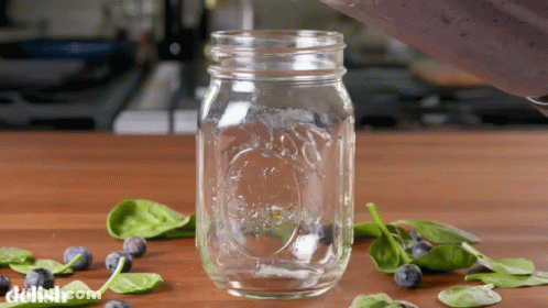 A Mason Jar With The Word Delish Written On The Bottom GIF