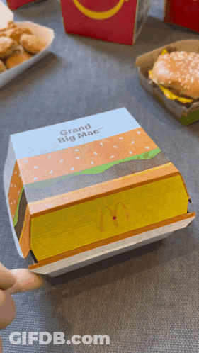 A Mcdonald 'S Box That Says Grand Big Mac On The Front GIF