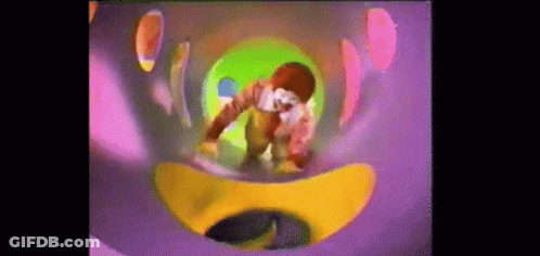 A Mcdonald 'S Character Is Playing In A Colorful Slide GIF