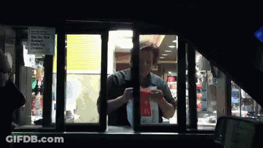 A Mcdonald 'S Drive Thru Window With A Sign That Says " We Do Not Accept Cash " GIF