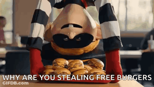 A Mcdonald 'S Mascot Is Holding A Tray Of Hamburgers . GIF