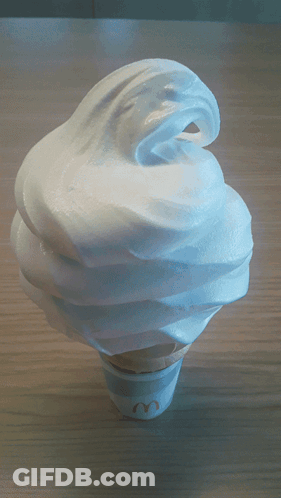 A Mcdonald 'S Soft Serve Ice Cream Cone With Whipped Cream On Top GIF