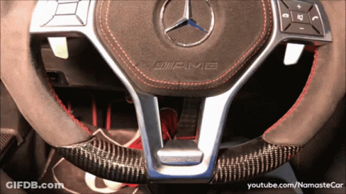 A Mercedes Amg Steering Wheel With A Carbon Fiber Steering Wheel Cover GIF