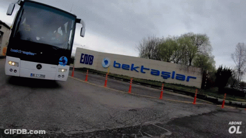 A Mercedes Bus Is Driving Past A Sign That Says Bektaslar GIF