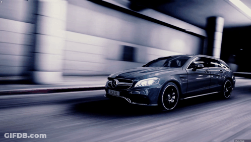 A Mercedes Cls 63 Amg Is Driving Down A Street GIF