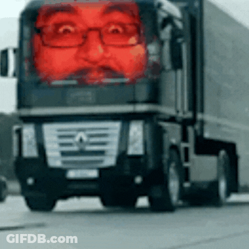 A Mercedes Truck With A Red Face On The Front GIF