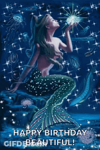 A Mermaid Is Sitting On A Rock In The Ocean And Holding A Star . GIF