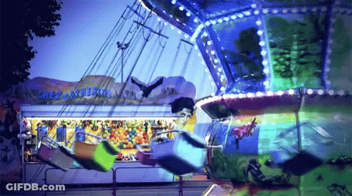 A Merry Go Round At A Carnival Has A Sign That Says " Great Escape " GIF