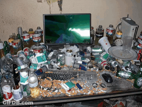A Messy Desk With A Dell Monitor And Coca Cola Bottles GIF