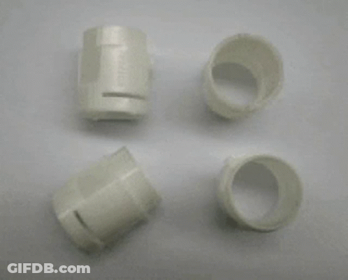 A Metal Mould With A Lot Of Holes In It Is Sitting On A White Surface . GIF