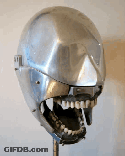 A Metal Skull With A Mouth Open And Teeth On It GIF