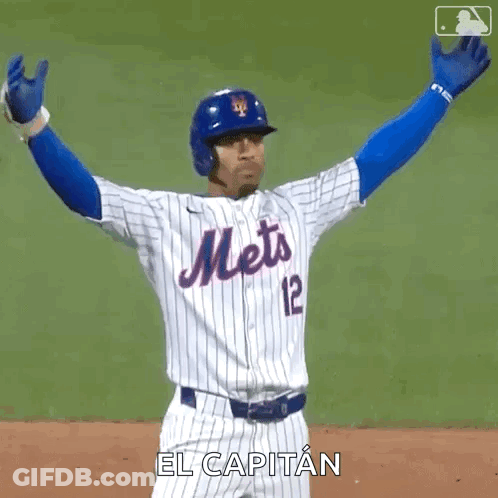 A Mets Baseball Player Is Raising His Arms In The Air . GIF