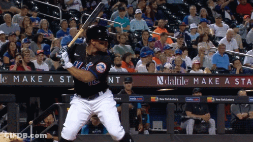 A Mets Baseball Player Swings At A Pitch GIF