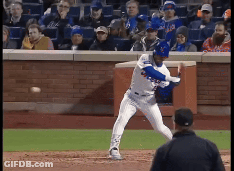 A Mets Baseball Player Swings His Bat At A Ball GIF