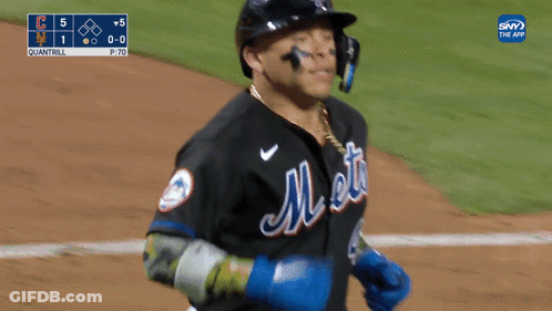A Mets Baseball Player Wearing A Helmet And A Chain Around His Neck GIF