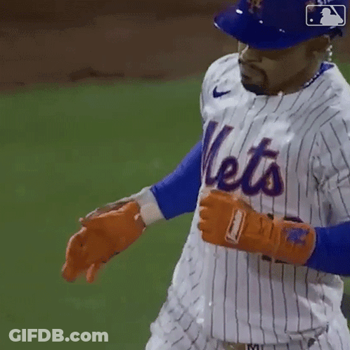 A Mets Player Wearing A Blue Helmet And A White Striped Jersey GIF