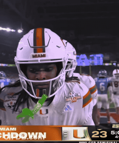 A Miami Football Player Holds A Green Gatorade Stick GIF