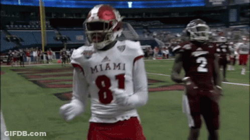 A Miami Football Player Wearing Number 81 Is Dancing On The Field GIF