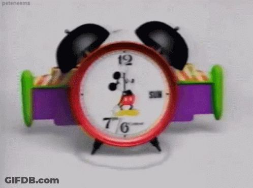 A Mickey Mouse Alarm Clock Shows That It Is 7:46 GIF