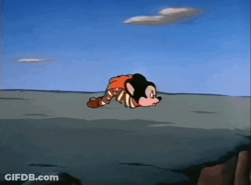 A Mickey Mouse Cartoon Character Is Laying On The Ground GIF
