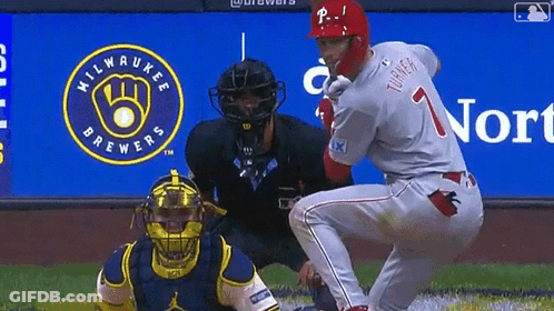 A Milwaukee Brewers Logo Is Behind The Baseball Player GIF